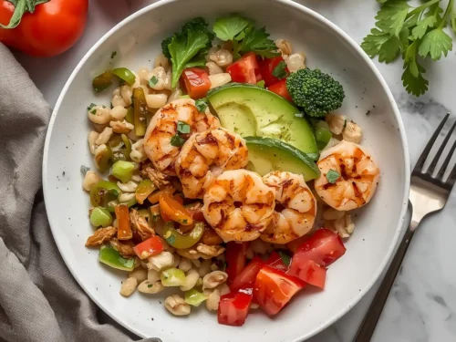An irresistible grilled shrimp grain bowl with fresh vegetables and a vibrant dressing