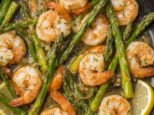 A serving of succulent Lemon Garlic Butter Shrimp with tender asparagus spears.