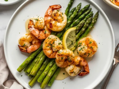 A serving of succulent Lemon Garlic Butter Shrimp with tender asparagus spears.
