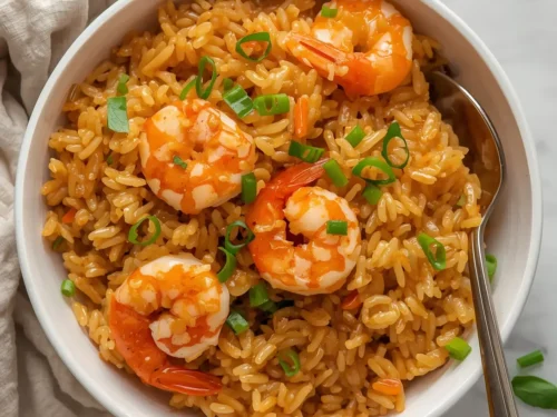 A vibrant one-pot shrimp fried rice dish in a large pan, ready to serve.