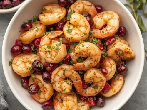 A vibrant roasted shrimp and cranberry salad with fresh greens and a light dressing.