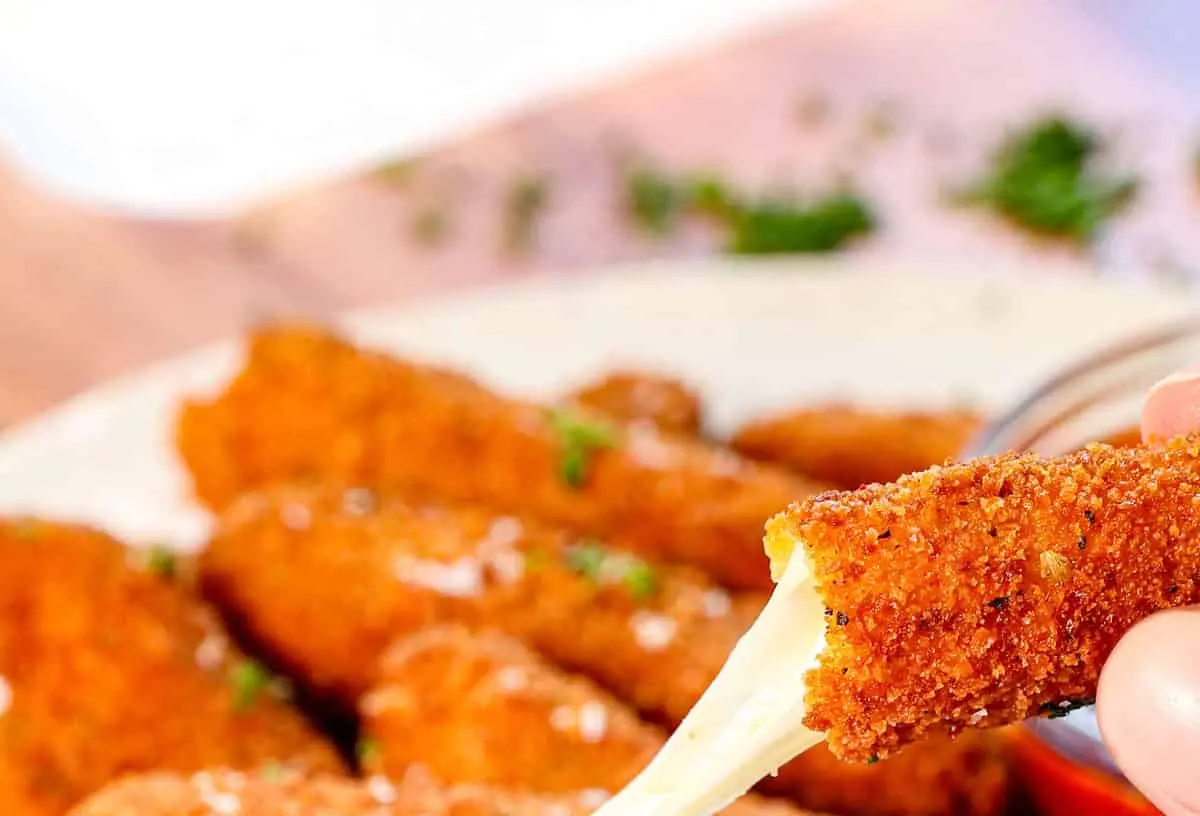 A plate of golden-brown mozzarella sticks, perfectly fried and ready to be served.