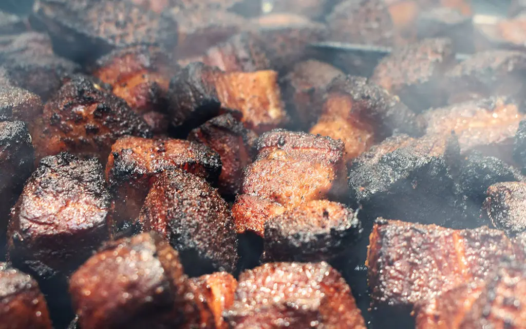 A serving of delicious Kansas City burnt ends, glistening with sauce.