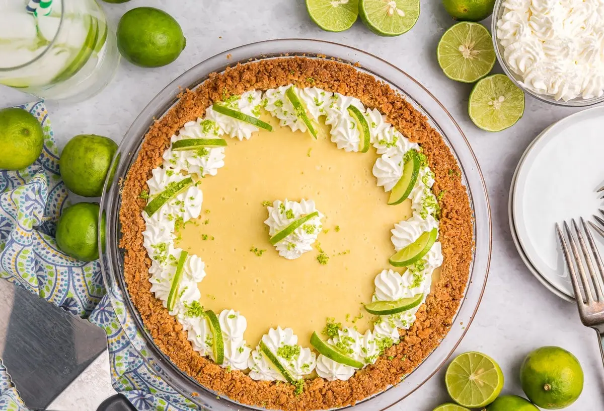A vibrant green key lime pie with whipped cream topping