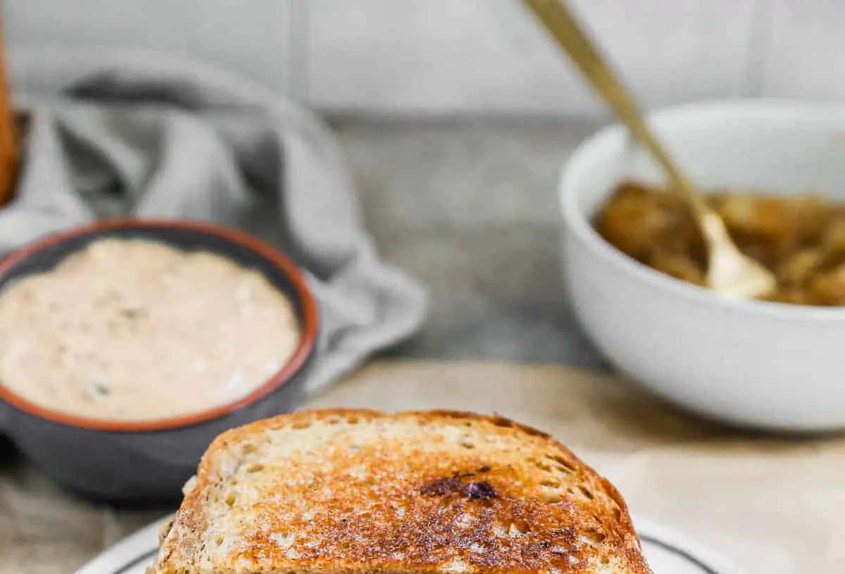 Close-up of a perfectly grilled patty melt sandwich with melted cheese
