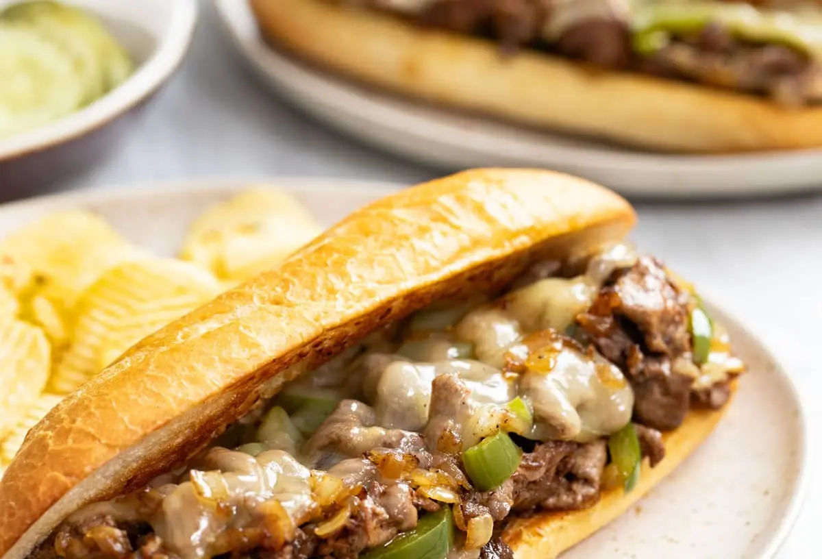 A delicious Philly cheesesteak with melted cheese and tender steak on a long roll