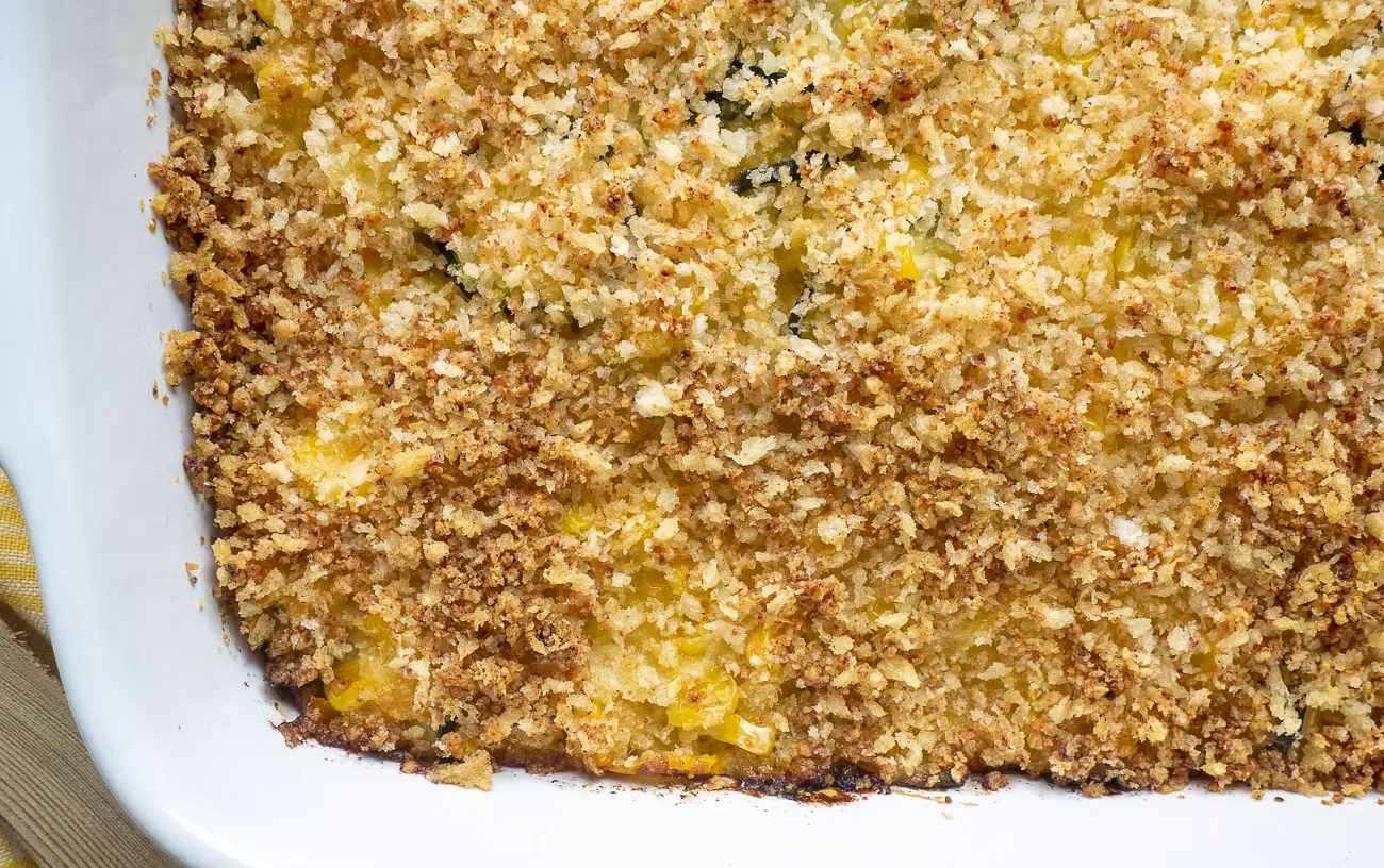 A baked squash zucchini casserole with golden-brown topping